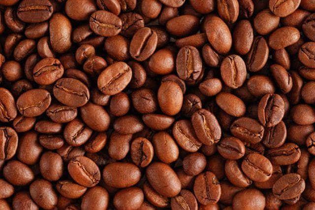 A close up of coffee beans on the ground